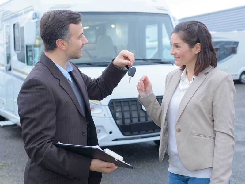 Happy woman after buying a caravan